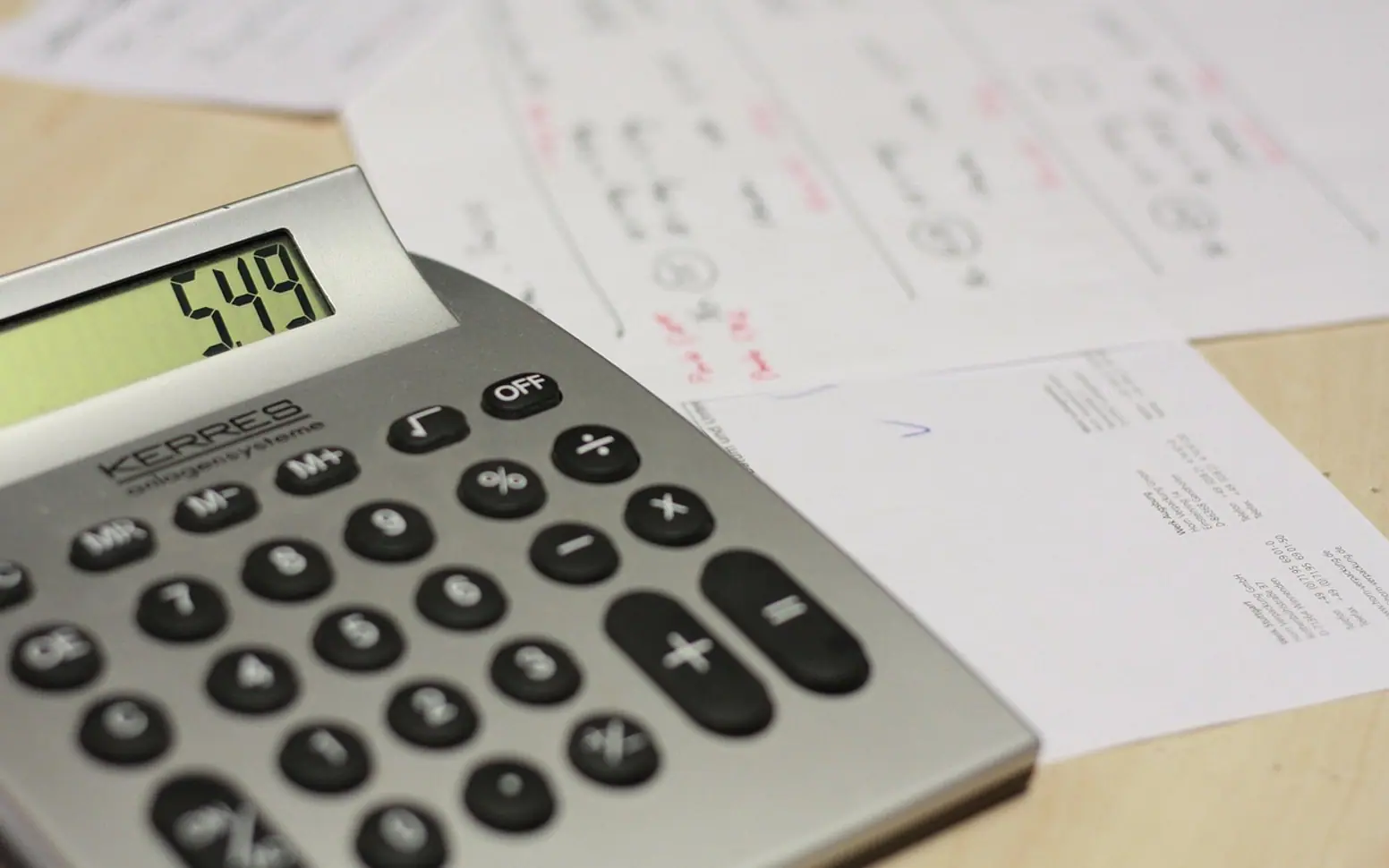 Calculator, table and invoice