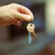 A hand holding keys to a home